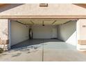 Clean and empty garage with an automatic door and ample space at 16008 N Hollyhock St, Surprise, AZ 85378