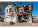 Two-story house with a white garage door and landscaping at 17774 W Watson Ln, Surprise, AZ 85388