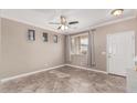 Bright living room with tiled floors and a ceiling fan at 17774 W Watson Ln, Surprise, AZ 85388