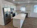 Modern kitchen featuring stainless steel appliances and an island at 17814 W Carol Ave, Waddell, AZ 85355