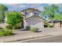 Two-story house with a two-car garage and mature landscaping at 1799 E Erie St, Gilbert, AZ 85295