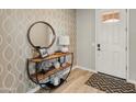 Modern entryway with a stylish console table and mirror at 18873 N 262Nd Dr, Buckeye, AZ 85396