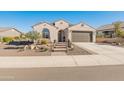 Single story home with attached two-car garage and desert landscaping at 18873 N 262Nd Dr, Buckeye, AZ 85396