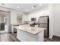 Beautiful kitchen featuring white cabinets, granite countertops, stainless steel appliances, and a center island at 22125 N 29Th Ave # 127, Phoenix, AZ 85027