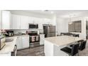 Modern kitchen with white shaker cabinets, stainless steel appliances, and an island at 22125 N 29Th Ave # 127, Phoenix, AZ 85027