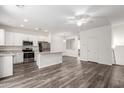 Spacious living room with modern kitchen, ceiling fan, and lots of natural light at 22125 N 29Th Ave # 127, Phoenix, AZ 85027