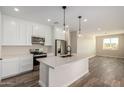 Modern kitchen with white cabinets, quartz countertops, and stainless steel appliances at 23437 E Cactus Forest Rd, Florence, AZ 85132