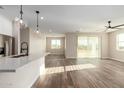 Open living area with wood-look floors and sliding glass doors to backyard at 23437 E Cactus Forest Rd, Florence, AZ 85132