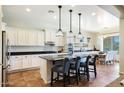 Modern kitchen with white cabinets, granite countertops, and an island at 28957 N 70Th Dr, Peoria, AZ 85383