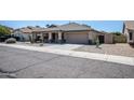 One-story house with a two-car garage, cacti, and gravel driveway at 3127 W Folgers Rd, Phoenix, AZ 85027