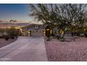 Beautiful home exterior with a three-car garage and desert landscaping at 32032 N 52Nd Way, Cave Creek, AZ 85331