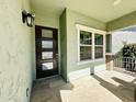 Front entry with dark brown door and light green walls at 3448 E Spring Wheat Ln, Gilbert, AZ 85296