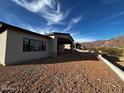 Exterior view of home with stucco walls and stunning mountain views at 4215 S Willow Springs Trl, Gold Canyon, AZ 85118