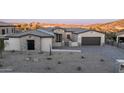 Desert home exterior featuring a paver driveway, stone accents, and desert landscaping at 4215 S Willow Springs Trl, Gold Canyon, AZ 85118