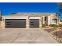 Two-story house with stone accents and a three-car garage at 4430 E Graythorn St, Phoenix, AZ 85044