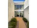 Modern glass entry doors leading to interior with a small courtyard at 4666 N 40Th St, Phoenix, AZ 85018