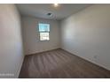 Spacious bedroom with neutral carpeting and a window with blinds at 47489 W Kenner Dr, Maricopa, AZ 85139