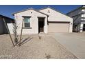 New single-story home with a two-car garage and desert landscaping at 47762 W Moeller Rd, Maricopa, AZ 85139