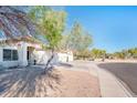 House with attached garage and mature trees in front at 5226 S 15Th St, Phoenix, AZ 85040