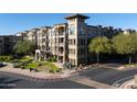 Three-story building exterior with parking and landscaping at 5350 E Deer Valley Dr # 4434, Phoenix, AZ 85054