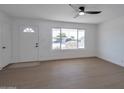 Bright living room featuring hardwood floors and large window at 5490 E Boise St, Mesa, AZ 85205