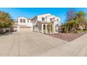 Two-story house with desert landscaping and a three-car garage at 5720 W Robb Ln, Glendale, AZ 85310