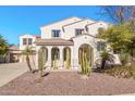 Two-story house with desert landscaping and a three-car garage at 5720 W Robb Ln, Glendale, AZ 85310