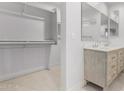 Main bathroom with double vanity, large closet, and neutral tile floors at 603 S 7Th St, Avondale, AZ 85323