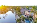 Aerial view showcasing a canal-front house with a pool and solar panels at 6811 W Monona Dr, Glendale, AZ 85308