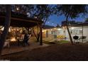 Backyard patio with fire pit, gazebo and grill at night at 7245 E Cambridge Ave, Scottsdale, AZ 85257