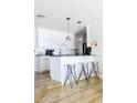 Modern kitchen with white cabinetry, breakfast bar, and pendant lighting at 7245 E Cambridge Ave, Scottsdale, AZ 85257