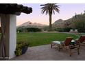 Landscaped backyard with mountain views and lounge chairs at 7348 N Red Ledge Dr, Paradise Valley, AZ 85253