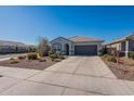 Single-story house with a two-car garage and nicely landscaped front yard at 7950 S 45Th Ave, Laveen, AZ 85339