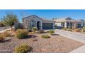 One-story home with gray exterior, two-car garage, and well-maintained landscaping at 7950 S 45Th Ave, Laveen, AZ 85339