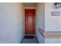 Red front door with a welcome mat and house number 7950 at 7950 S 45Th Ave, Laveen, AZ 85339