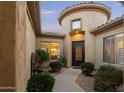 Charming courtyard entry with a circular wall and lush greenery at 8531 E Twisted Leaf Dr, Gold Canyon, AZ 85118