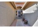 Brick entryway with arched walkway and security door at 9 N Agua Fria Ln, Casa Grande, AZ 85194