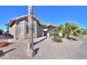 House exterior with stone accents and palm trees at 9 N Agua Fria Ln, Casa Grande, AZ 85194