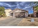 Single-story house with a two-car garage and desert landscaping at 9909 W Miami St, Tolleson, AZ 85353