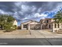 One-story house with a two-car garage and driveway at 9909 W Miami St, Tolleson, AZ 85353