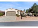 Charming single-story home with a two car garage and well-maintained desert landscaping at 12808 W Nogales Dr, Sun City West, AZ 85375