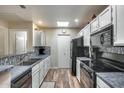 Well-equipped kitchen featuring modern appliances and wood flooring at 14300 W Bell Rd # 488, Surprise, AZ 85374