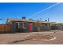 Updated mid-century modern home with gray exterior and red door at 2101 N Normal Ave, Tempe, AZ 85288