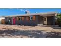 Ranch home with gray exterior, red door, and covered carport at 2101 N Normal Ave, Tempe, AZ 85288