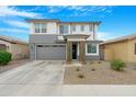 Two-story home featuring a modern exterior, neutral colors, and a two car garage at 22501 E Indiana Ave, Queen Creek, AZ 85142