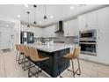 Spacious kitchen featuring a large island with seating and modern appliances at 22501 E Indiana Ave, Queen Creek, AZ 85142
