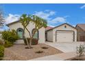 Curb appeal abounds in this one-story home featuring a two-car garage and desert landscaping at 24147 N 165Th Ln, Surprise, AZ 85387