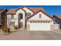 Two-story house with a large garage and landscaped yard at 2442 E Winged Foot Dr, Chandler, AZ 85249