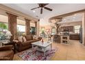 Open concept kitchen and living area with island and breakfast bar at 28175 N 123Rd Ln, Peoria, AZ 85383