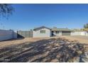 Updated ranch home with gray exterior, two-car garage, and gated driveway at 2914 E Cactus Rd, Phoenix, AZ 85032